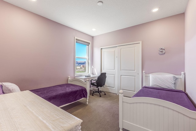 carpeted bedroom featuring a closet and recessed lighting