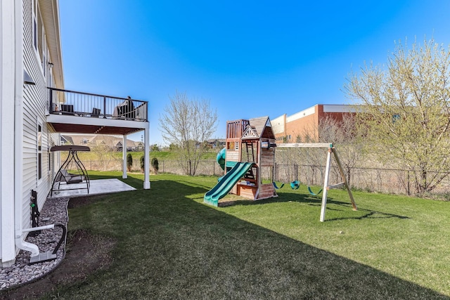 view of play area featuring a patio, a fenced backyard, and a yard