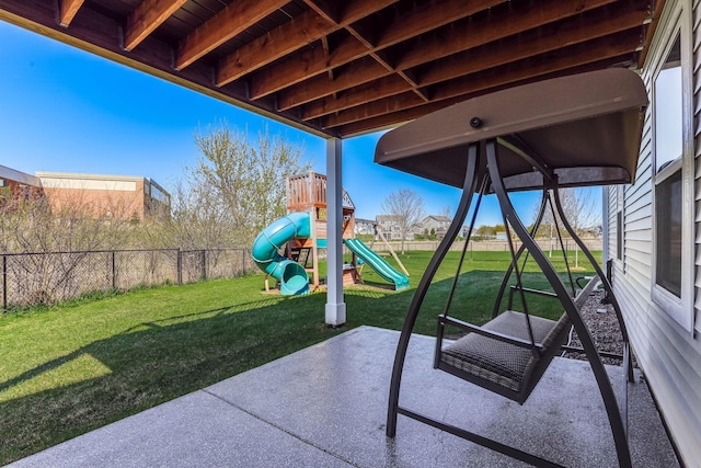 view of patio / terrace featuring a playground and fence