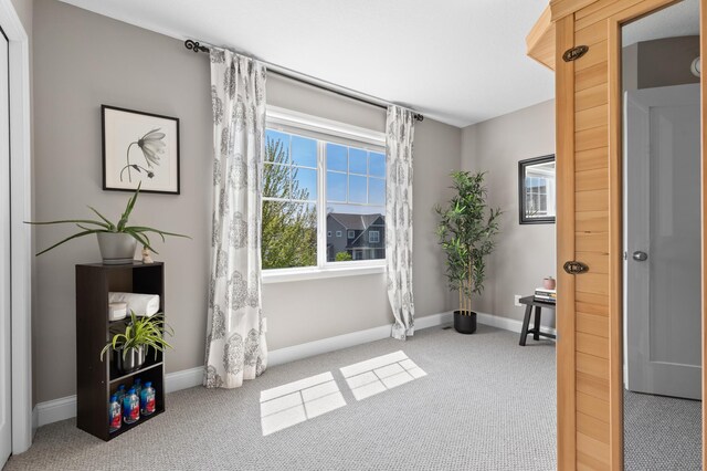 unfurnished room with carpet floors and baseboards