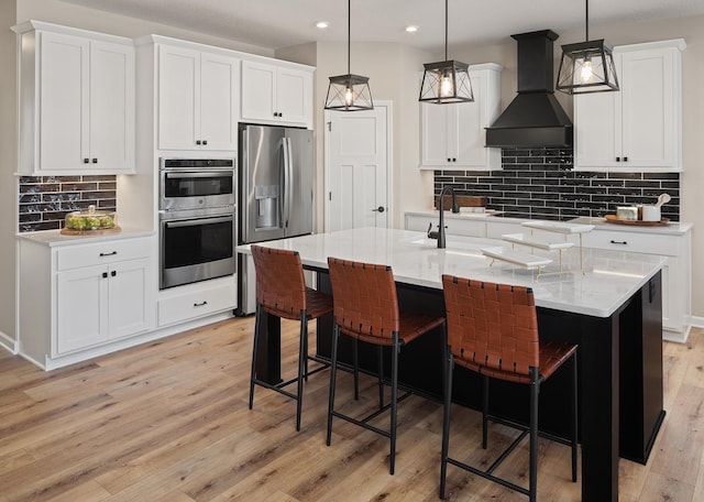 kitchen with premium range hood, appliances with stainless steel finishes, backsplash, recessed lighting, and light wood finished floors