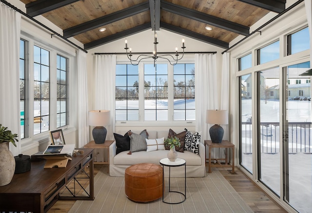 sunroom / solarium featuring a chandelier