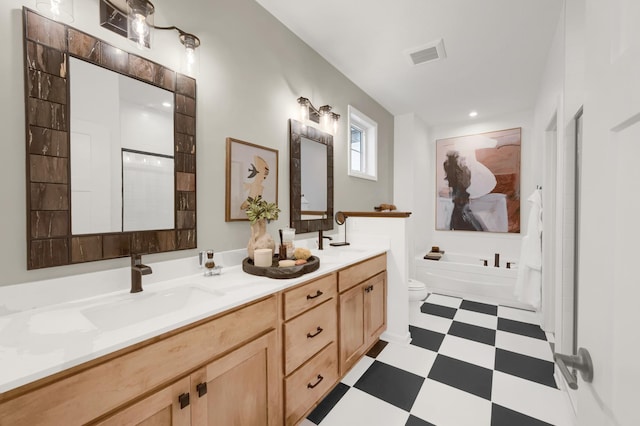 bathroom with tile patterned floors, double vanity, a bath, and toilet