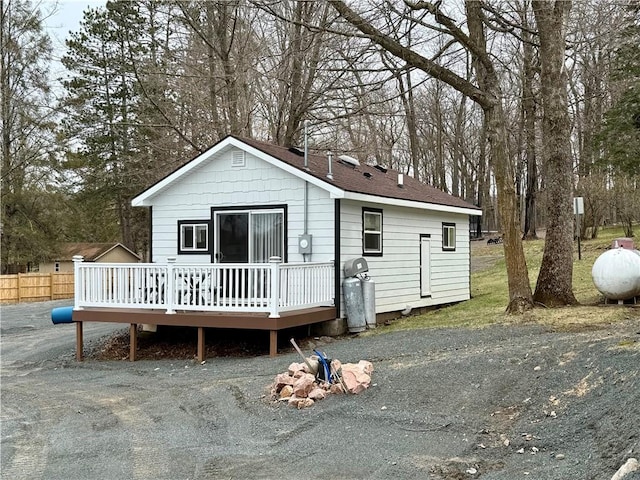 view of front of property featuring fence and a wooden deck