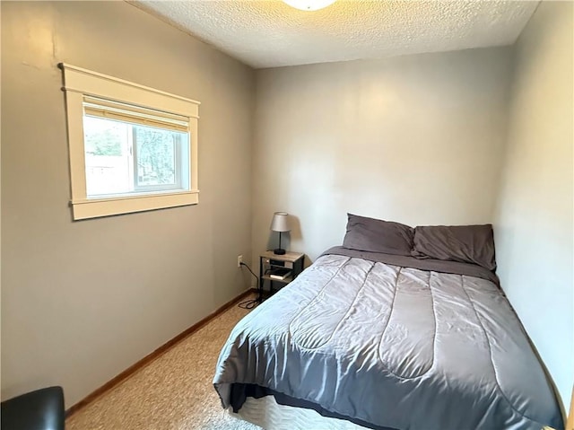 bedroom with carpet floors, a textured ceiling, and baseboards