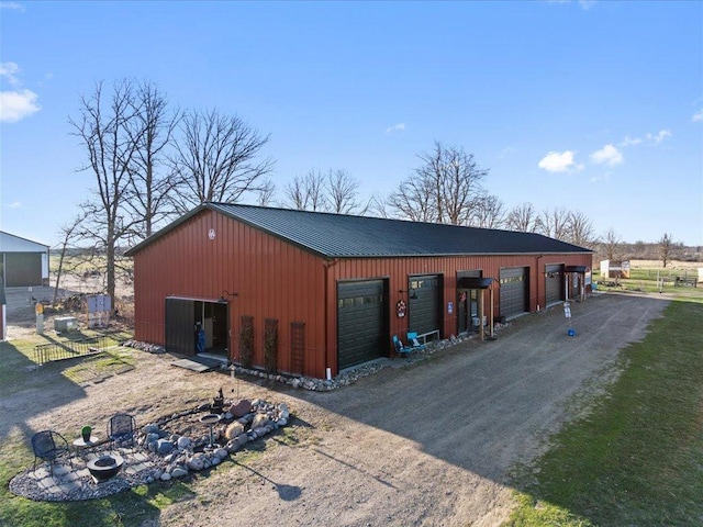 detached garage with dirt driveway