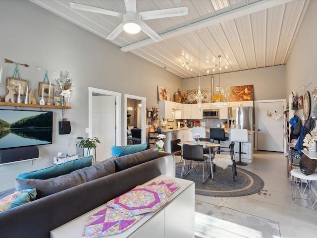 living area featuring a towering ceiling and ceiling fan