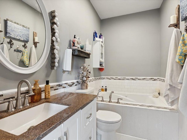 full bathroom with a bath, vanity, and toilet