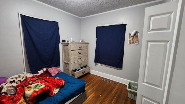 1110 Oakland Ave, Austin, MN 55912 - bedroom with dark wood finished floors, ornamental molding, a textured ceiling, and baseboards