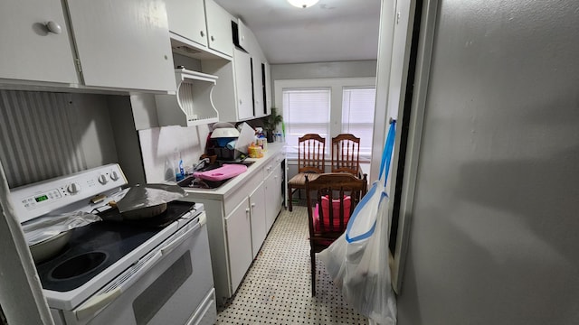 1110 Oakland Ave, Austin, MN 55912 - kitchen featuring white range with electric stovetop, light floors, white cabinetry, light countertops, and a sink