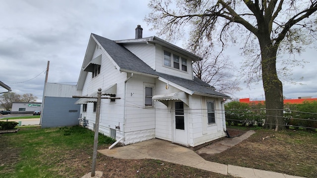 1110 Oakland Ave, Austin, MN 55912 - back of house with a chimney and a shingled roof