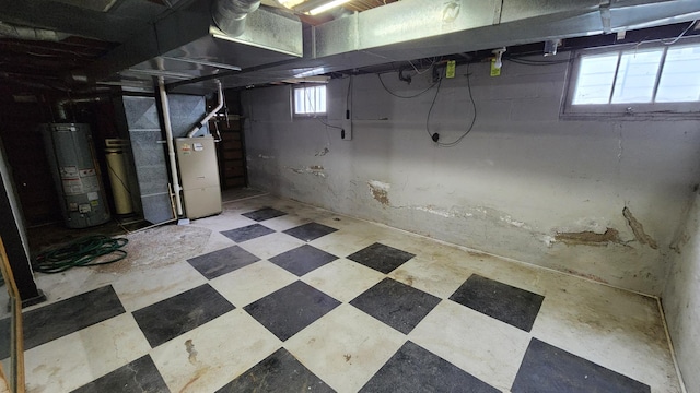 1110 Oakland Ave, Austin, MN 55912 - below grade area featuring water heater, tile patterned floors, and heating unit