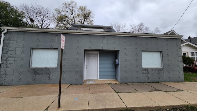 1110 Oakland Ave, Austin, MN 55912 - back of property featuring concrete block siding and a patio area