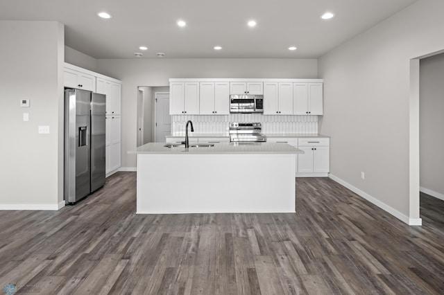kitchen featuring a sink, white cabinetry, tasteful backsplash, and stainless steel appliances