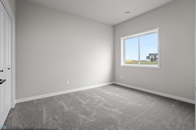 empty room with carpet flooring and baseboards