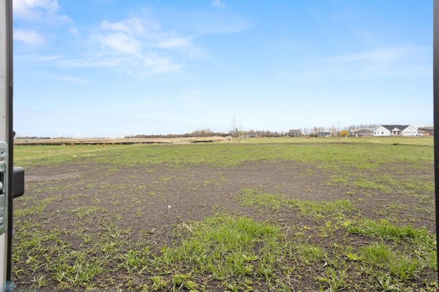 view of yard with a rural view