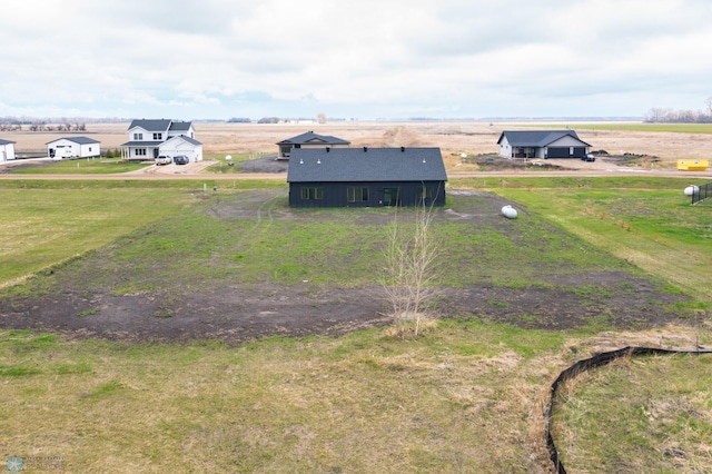 birds eye view of property with a rural view