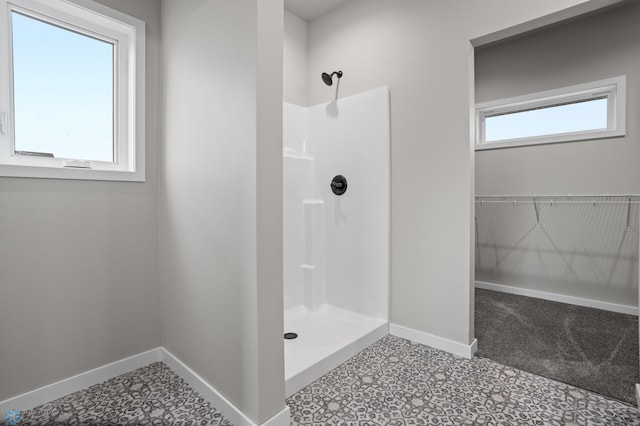 full bath with baseboards and walk in shower