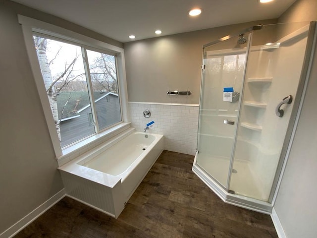 bathroom featuring a garden tub, tile walls, recessed lighting, a wainscoted wall, and a stall shower