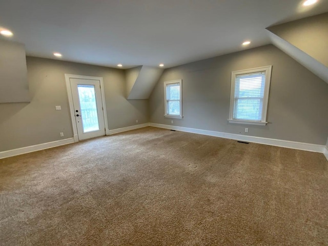 additional living space featuring recessed lighting, carpet flooring, and plenty of natural light