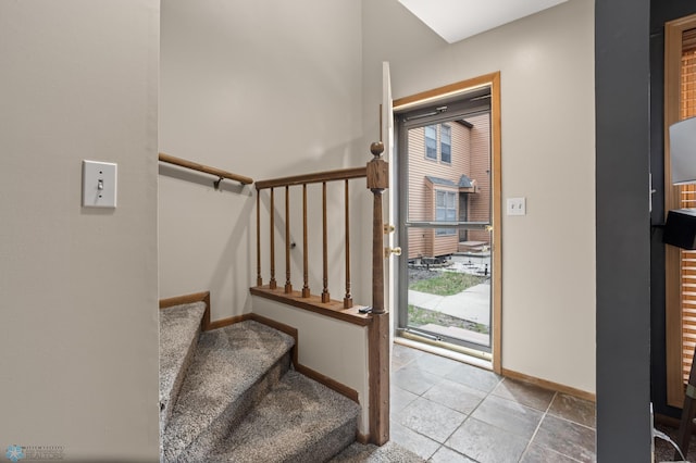 staircase featuring baseboards