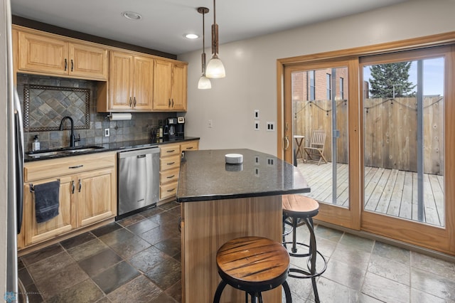 kitchen with stainless steel appliances, a sink, stone tile floors, decorative backsplash, and a breakfast bar area