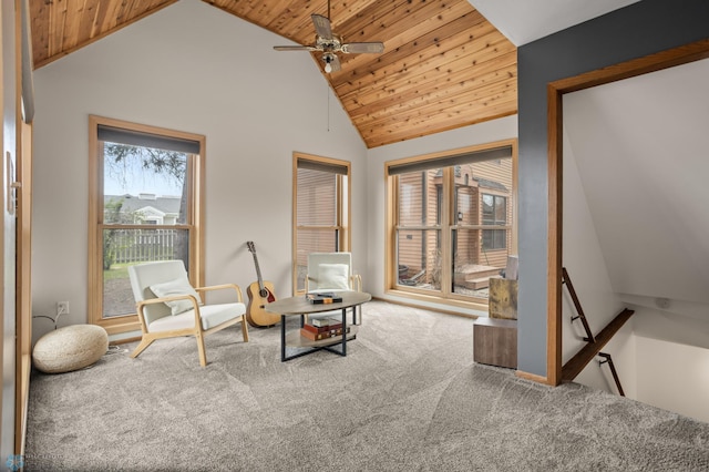 sitting room featuring wooden ceiling, carpet, a ceiling fan, an upstairs landing, and high vaulted ceiling