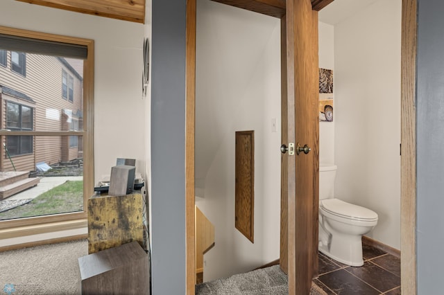 bathroom with toilet and baseboards