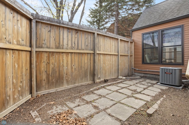 view of patio / terrace featuring central AC unit and fence