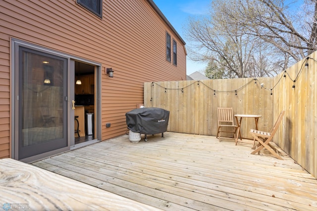 wooden deck with grilling area and fence