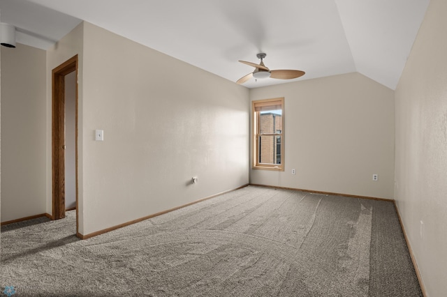 unfurnished room featuring carpet flooring, ceiling fan, vaulted ceiling, and baseboards