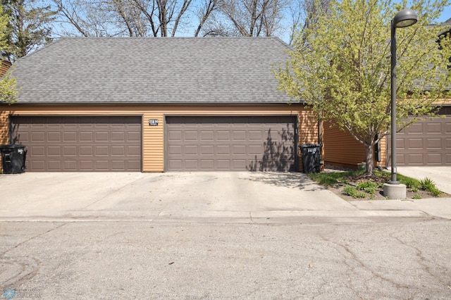 garage featuring concrete driveway