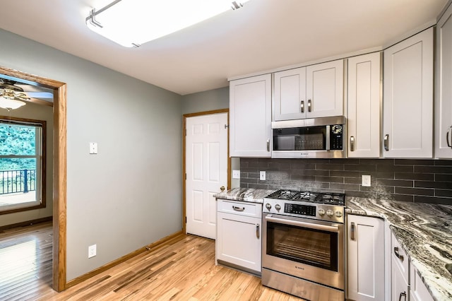 1877 Quasar Ave S, Lake Saint Croix Beach, MN 55043 - kitchen featuring stainless steel appliances, light wood-style floors, tasteful backsplash, and stone counters