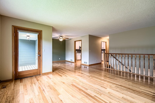 1877 Quasar Ave S, Lake Saint Croix Beach, MN 55043 - spare room featuring wood finished floors, a textured ceiling, and a ceiling fan