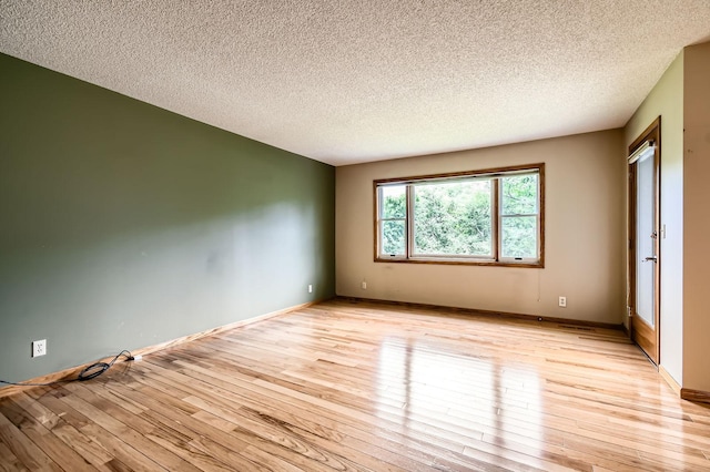 1877 Quasar Ave S, Lake Saint Croix Beach, MN 55043 - empty room with light wood-style floors and a textured ceiling