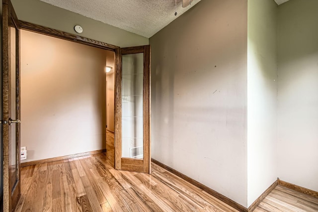 1877 Quasar Ave S, Lake Saint Croix Beach, MN 55043 - unfurnished room featuring a textured ceiling, light wood-type flooring, and a smoke detector
