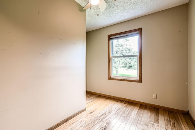 1877 Quasar Ave S, Lake Saint Croix Beach, MN 55043 - spare room featuring light wood finished floors, a textured ceiling, and a ceiling fan