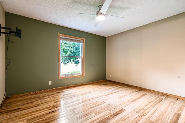 1877 Quasar Ave S, Lake Saint Croix Beach, MN 55043 - unfurnished room with light wood finished floors, a textured ceiling, and a ceiling fan