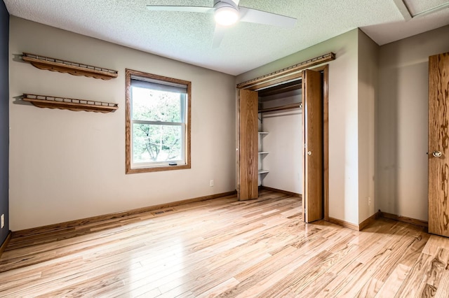 1877 Quasar Ave S, Lake Saint Croix Beach, MN 55043 - unfurnished bedroom featuring light wood-style flooring, a textured ceiling, a closet, and ceiling fan