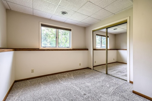 1877 Quasar Ave S, Lake Saint Croix Beach, MN 55043 - unfurnished bedroom with a paneled ceiling, carpet floors, and a closet