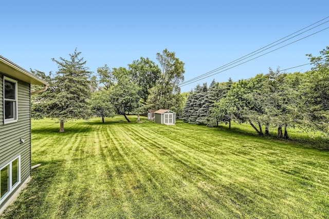 1877 Quasar Ave S, Lake Saint Croix Beach, MN 55043 - view of grassy yard with a storage unit