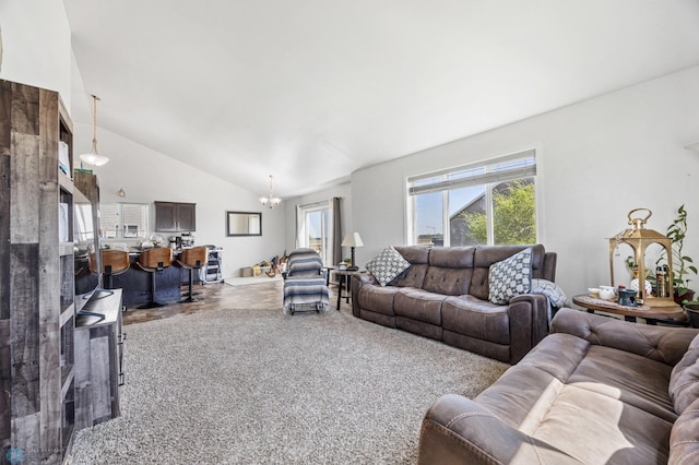 living room with a chandelier and high vaulted ceiling