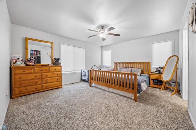 bedroom with carpet, ceiling fan, and baseboards