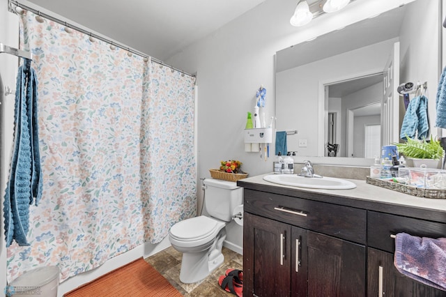 bathroom featuring toilet and vanity