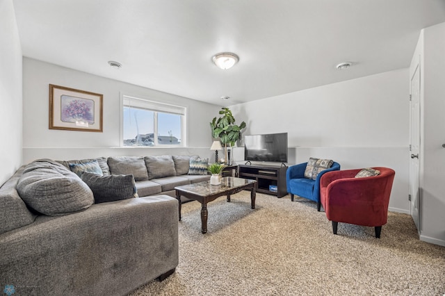 living area featuring carpet flooring and baseboards