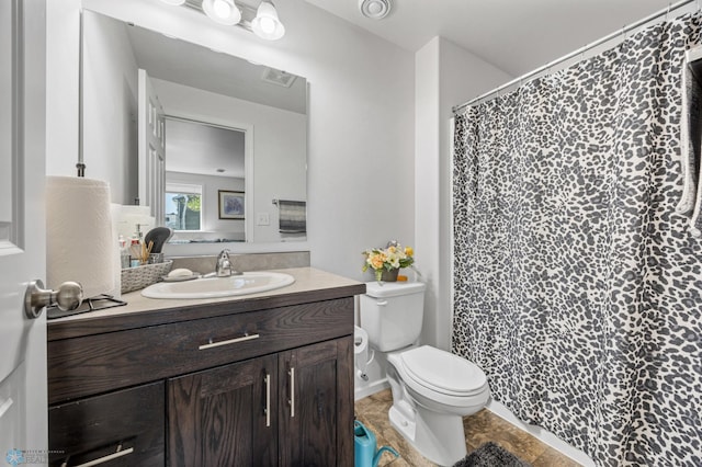 bathroom featuring toilet, vanity, and curtained shower