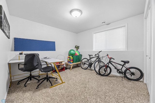 carpeted office featuring baseboards