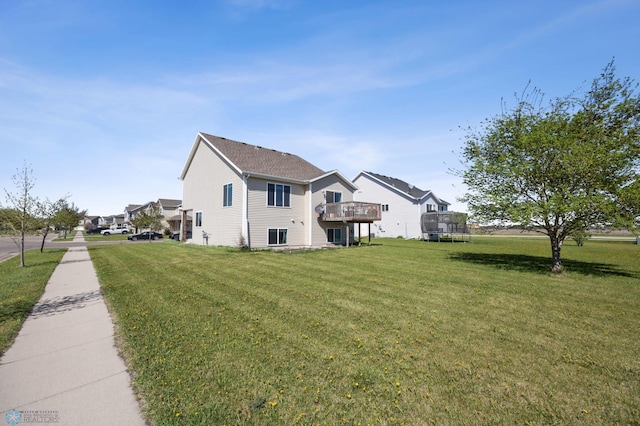 view of side of home featuring a lawn and a deck
