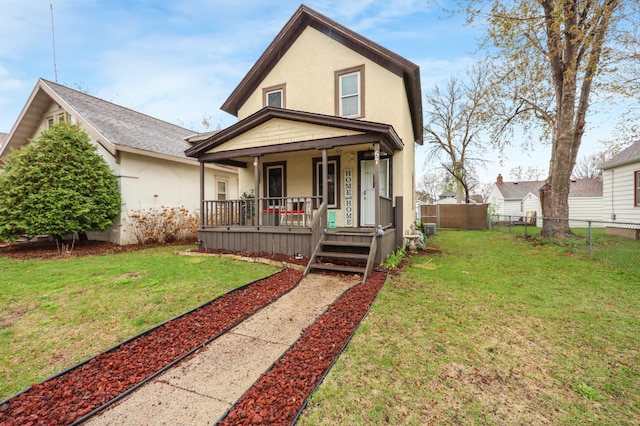 view of front of property featuring covered porch, stucco siding, fence private yard, and a front lawn