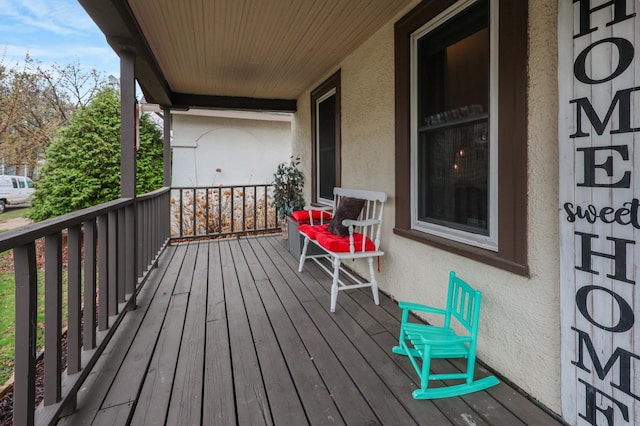 wooden terrace featuring covered porch